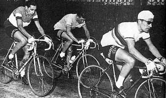 Stan, in zijn regenboogtrui, vóór Louison Bobet en Fausto Coppi. 